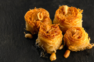 Baklava made of thin dough with chopped nuts and honey syrup. Traditional Oriental sweets closeup....