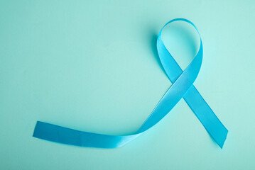 Blue ribbon on background. Prostate cancer awareness month. Blue ribbon symbol of world prostate cancer month and concept of healhcare. Copy space.