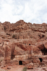 Fototapeta premium Stone tombs carved into the mountain in the ancient city of Petra in Jordan
