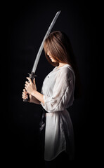 Beautiful asian lady with katana sword. Ninja samurai female warrior concept. Vertical studio photography. © Dmytro