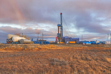 Infrastructure for drilling oil and gas wells in the Far North in the Arctic zone of Russia. Autumn. In the foreground is the vegetation of the polar tundra. Beautiful sky