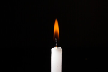 Burning candle on a dark background