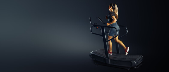 Running woman. Female athlete doing High Intensity Interval Training on Motorless Curved Sprint Treadmill. Conceptual wide banner studio photo. Training at home