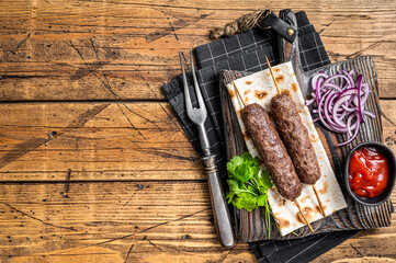Traditional middle east kefta, kofta kebab from ground beef and lamb meat grilled on skewers served...
