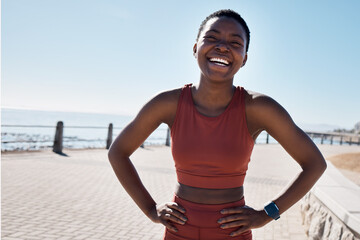 Fitness, black woman and portrait of a runner by the sea with happiness and smile training. Relax, happy and workout of a athlete doing sport, marathon and exercise ready for cardio running