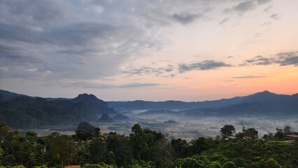 Fototapeta premium Beautiful bird's-eye view of the sea of mist in the green mountain forest, Phu Chee Fah, Thoeng District, Chiang Rai, Thailand.