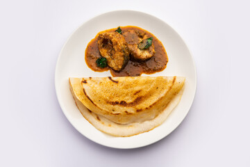 dosa with with fish curry from south Indian non vegetarian cuisine served in a plate