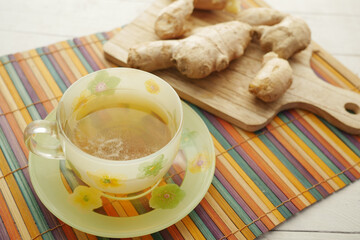 Ginger tea on wooden background.