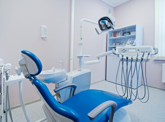 Modern dental office interior with equipment, patient chair and dentist's workplace in hospital