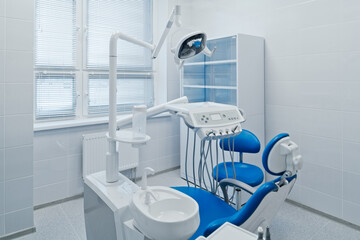 Modern dental office interior with equipment, patient chair and dentist's workplace in hospital