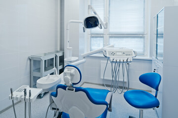Modern dental office interior with equipment, patient chair and dentist's workplace in hospital