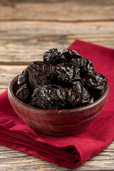 Bowl with prunes on the table.