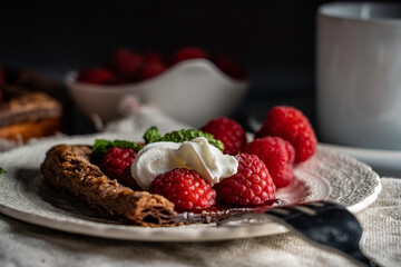 raspberry tart on chocolate puff pastry garnished with mint leaves
.