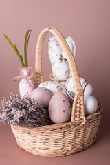 A wicker basket with Easter eggs and lavender sprigs. Easter card