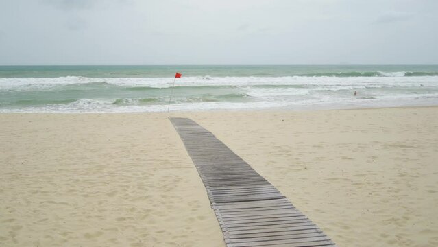 Waves on the sea. A red flag banning bathing. Cam Ranh in winter in Vietnam.