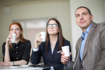 Business people in a meeting take a coffee break while talking and solving problems