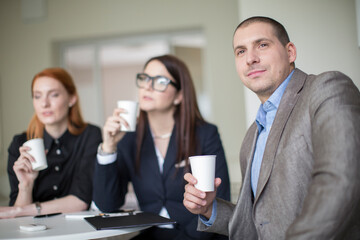 Business people talking and drinking coffee during a break during a meeting