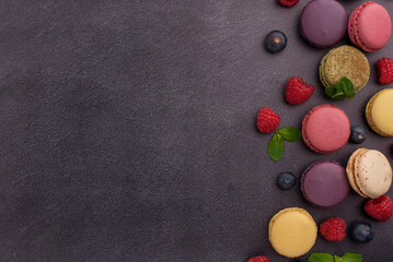 Color macaroons background with fruits, flatlay
