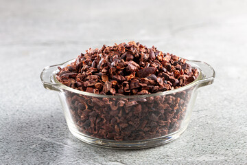 Bowl with cocoa nibs on the table.