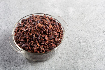 Bowl with cocoa nibs on the table.