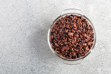 Bowl with cocoa nibs on the table.