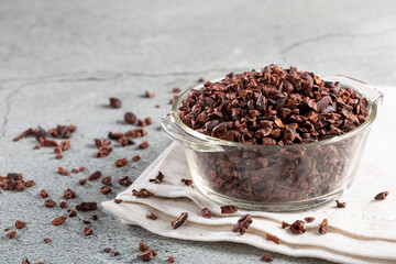 Bowl with cocoa nibs on the table.