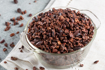Bowl with cocoa nibs on the table.
