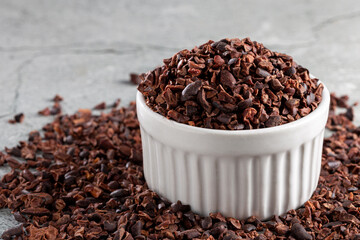 Bowl with cocoa nibs on the table.
