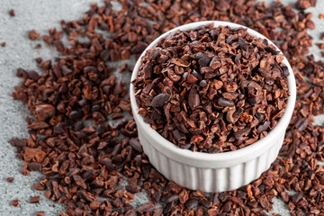 Bowl with cocoa nibs on the table.