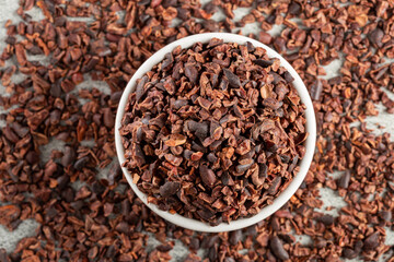 Bowl with cocoa nibs on the table.