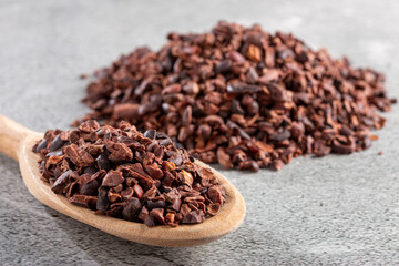 Bowl with cocoa nibs on the table.