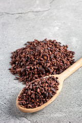 Bowl with cocoa nibs on the table.