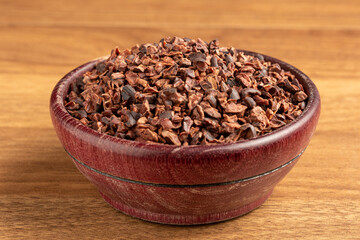 Bowl with cocoa nibs on the table.