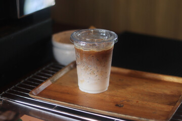 Closeup of Iced Caramel Macchiato at the coffee shop, Caramel Macchiato is a classic macchiato beverage. It consists of vanilla syrup, espresso, steamed milk, foam, and caramel drizzle