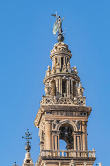 Fototapeta na wymiar Roman Catholic Cathedral of Saint Mary of the See (Catedral de Santa Maria de la Sede, 1528). Giralda (La Giralda) - 104.1 m bell tower of Seville Cathedral. Seville, Andalusia, Spain.
