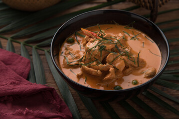 Thai curry red soup,Thailand tradition red curry with beef,pork or chicken menu in thai name is panaeng.Curry menu with coconut milk.Panaeng Curry on Wooden table