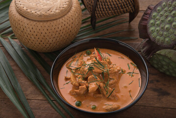 Thai curry red soup,Thailand tradition red curry with beef,pork or chicken menu in thai name is panaeng.Curry menu with coconut milk.Panaeng Curry on Wooden table