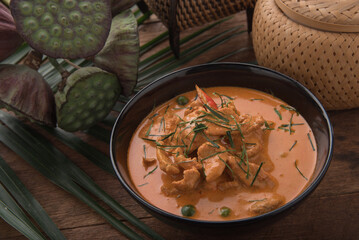 Thai curry red soup,Thailand tradition red curry with beef,pork or chicken menu in thai name is panaeng.Curry menu with coconut milk.Panaeng Curry on Wooden table
