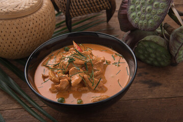 Thai curry red soup,Thailand tradition red curry with beef,pork or chicken menu in thai name is panaeng.Curry menu with coconut milk.Panaeng Curry on Wooden table