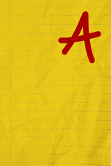 Getting a grade A message on yellow ruled line crumpled paper