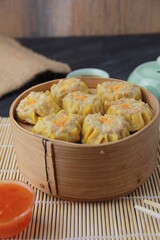 siomay dimsum filled with prawns, chicken, spring onions, on black background