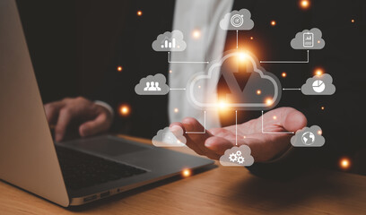 Selective focus at the icon with hand of businessman that holding cloud icon while who using internet and personal cloud storage to keep information and payment data, upload over the internet.