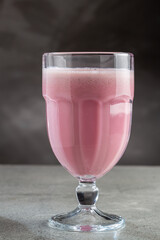 Glass with tasty strawberry smoothie.