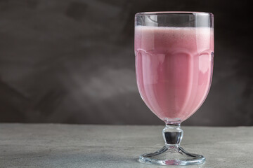 Glass with tasty strawberry smoothie.