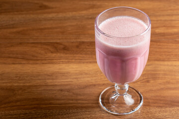 Glass with tasty strawberry smoothie.