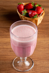 Glass with tasty strawberry smoothie.