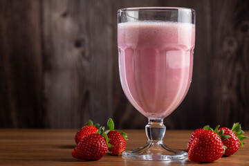 Glass with tasty strawberry smoothie.