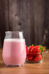 Glass with tasty strawberry smoothie.