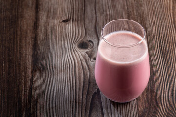 Glass with tasty strawberry smoothie.