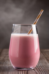Glass with tasty strawberry smoothie.